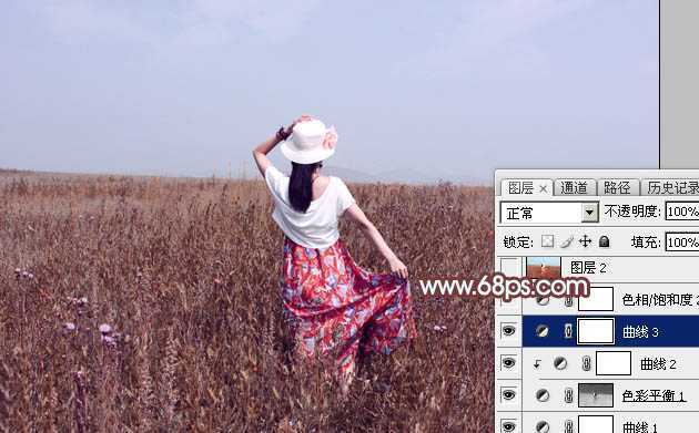 ‘Photoshop为荒草中的美女加上唯美的秋季红褐色‘